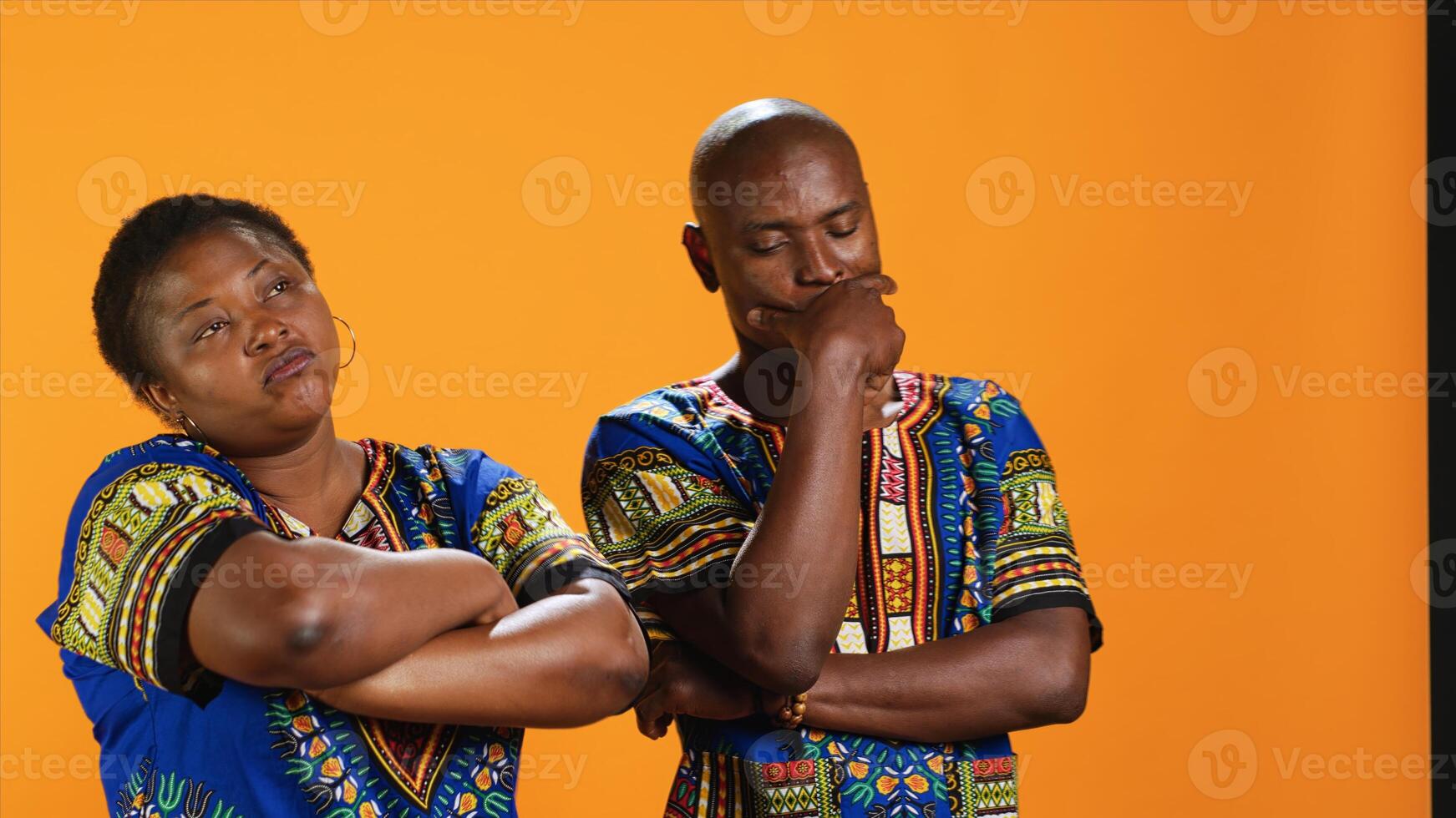 Pensive ethnic couple thinking about new ideas and solutions, discussing about possibilities and rubbing chin. Uncertain man and woman being thoughtful and contemplating about something. photo