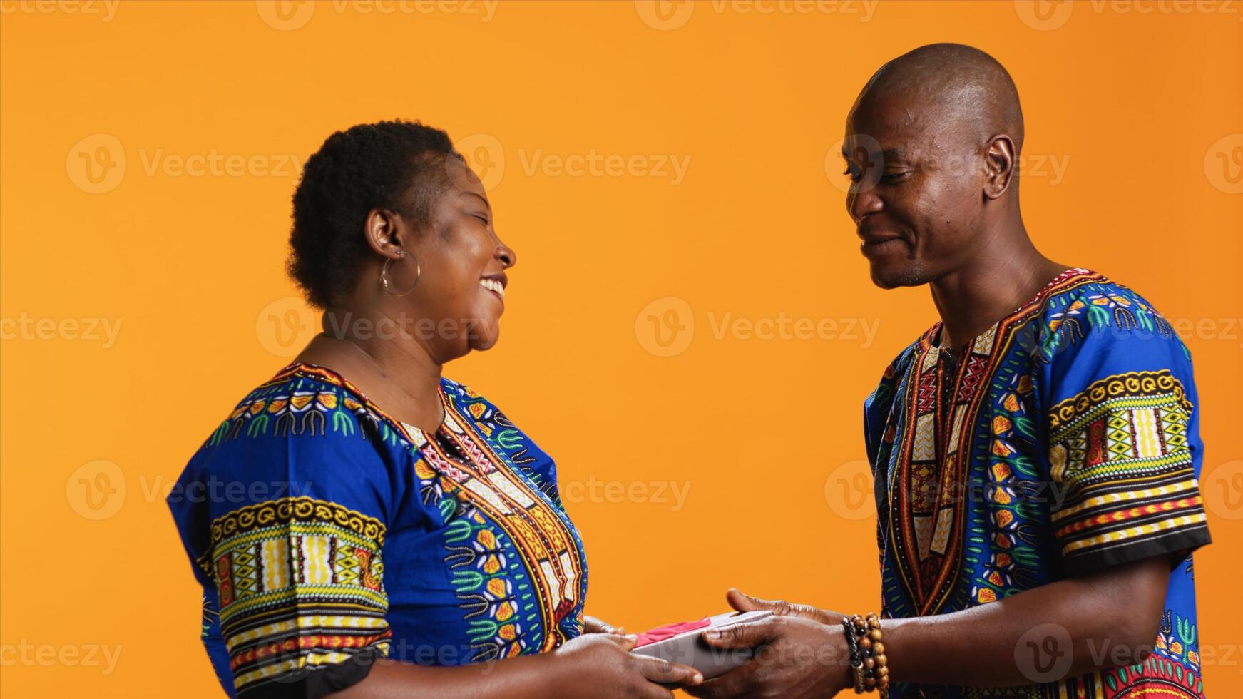 Sweet husband giving giftbox with ribbon to his wife, celebrating her birthday or valentines day with romantic gesture. Young man offering anniversary wrapped present to surprised woman. photo