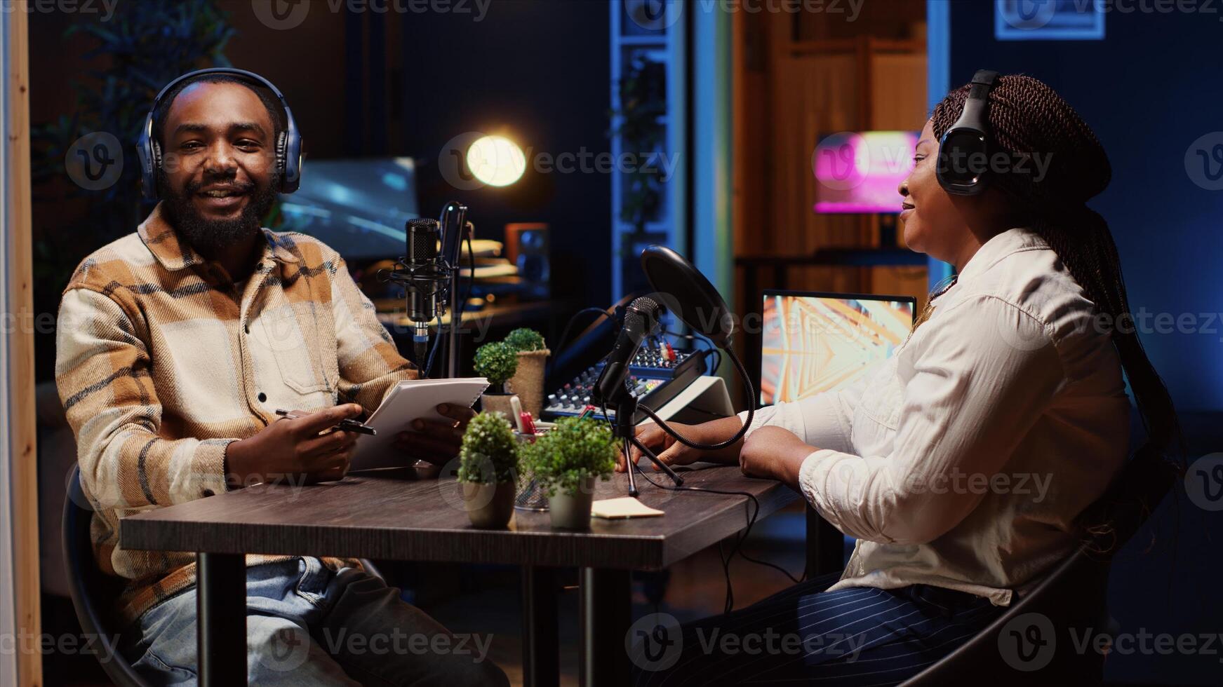 Man using high tech microphones to ensure optimum sound quality for audience listening at home while interviewing guest. Happy content creator using professional audio gear, presenting interviewee photo