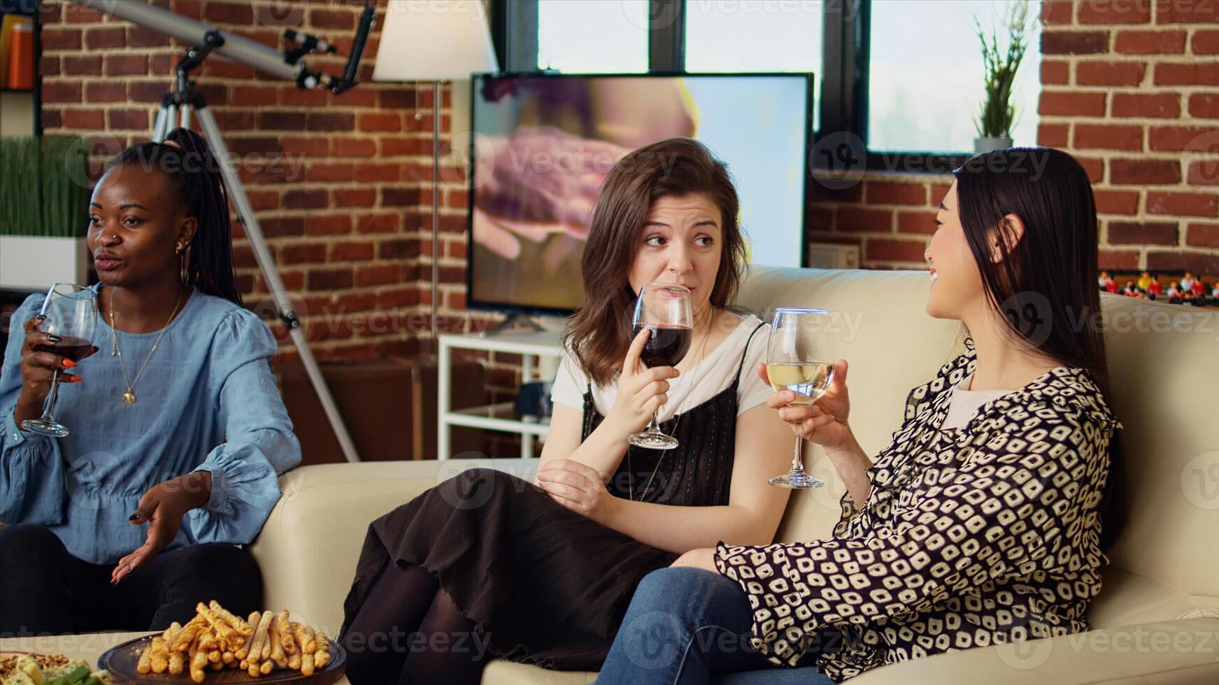 Multiracial company workers celebrating business success at work, gathered at home to toast champagne glasses for their accomplishments, throwing apartment party, eating snacks photo