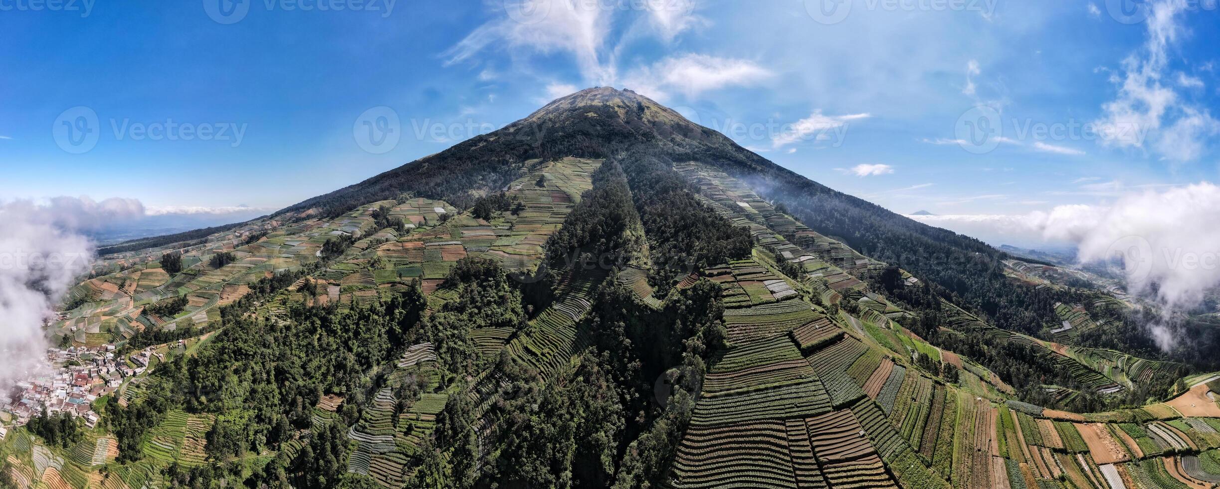 beautiful view of Mount Sumbing when the weather is clear, the sky is blue with a few clouds. Located in Central Java, Indonesia. photo