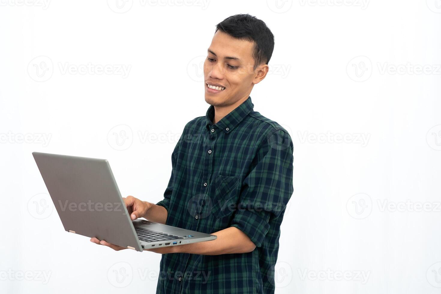 Asian man wearing a green checkered casual shirt is showing a laptop. business photo concept, student. Isolated white background.