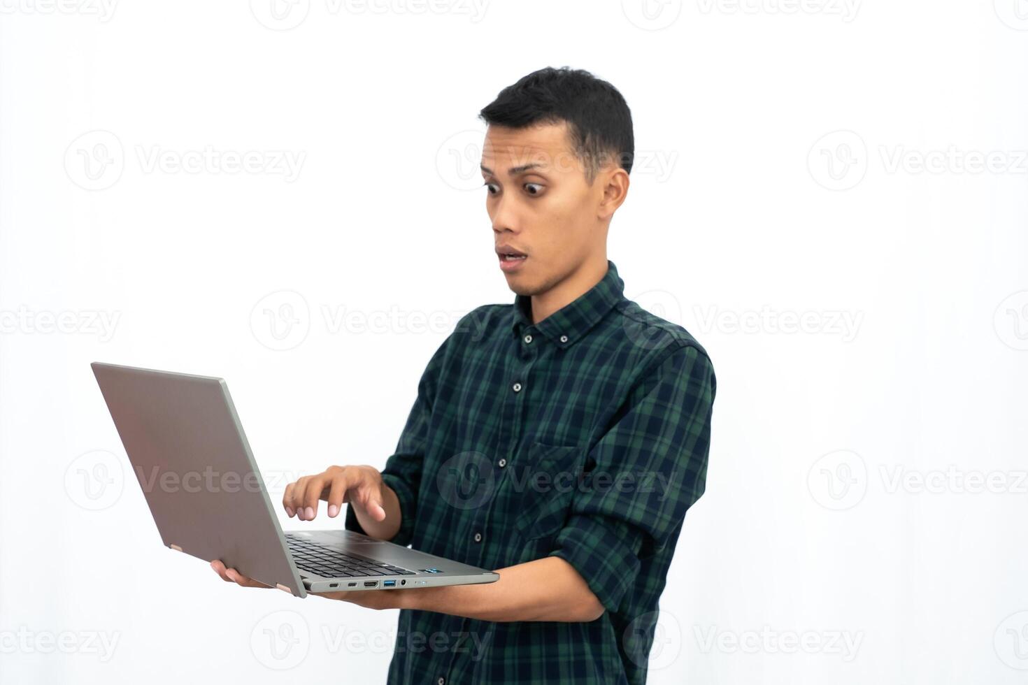 Asian man wearing a green checkered casual shirt is showing a laptop. business photo concept, student. Isolated white background.
