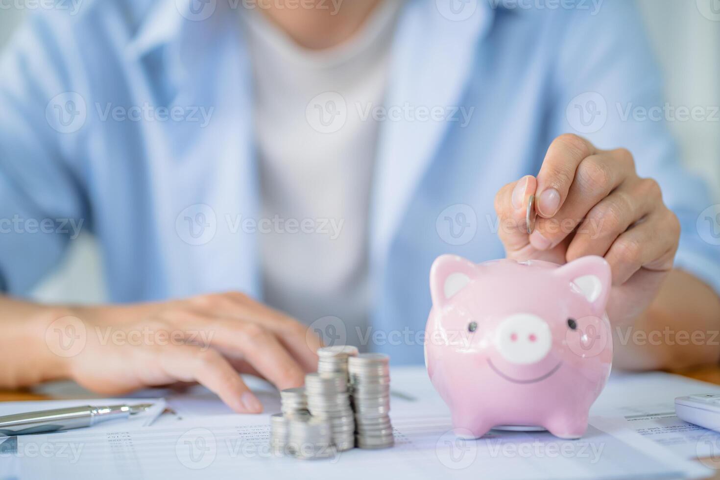 Saving money. Businessman Accountant verify growing business and saving money stacking coins with calculator. Accountancy Concept. photo