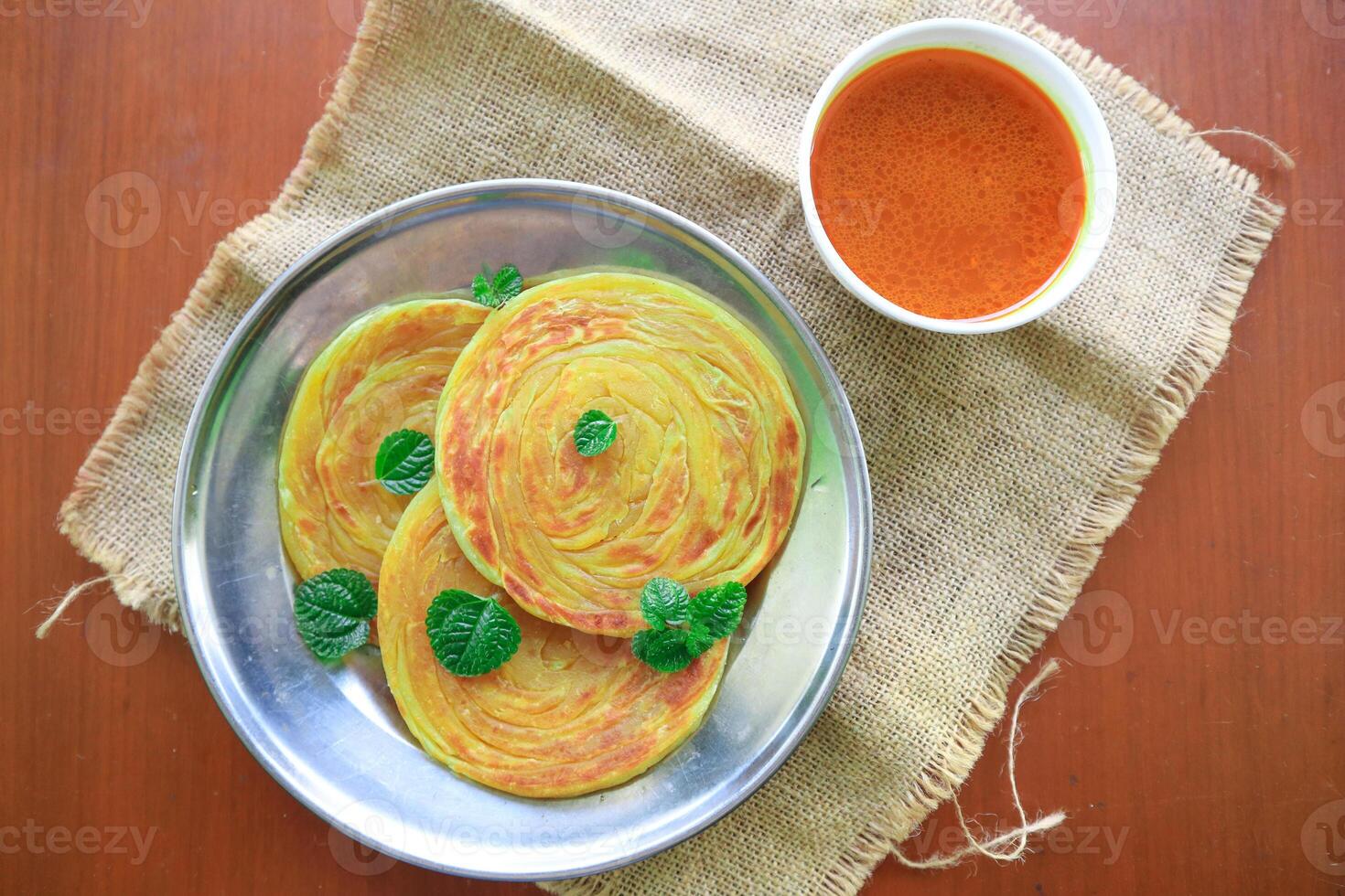 Roti Canai or Paratha Bread with Curry Sauce, Chilli Flakes and Yogurt, Top View photo