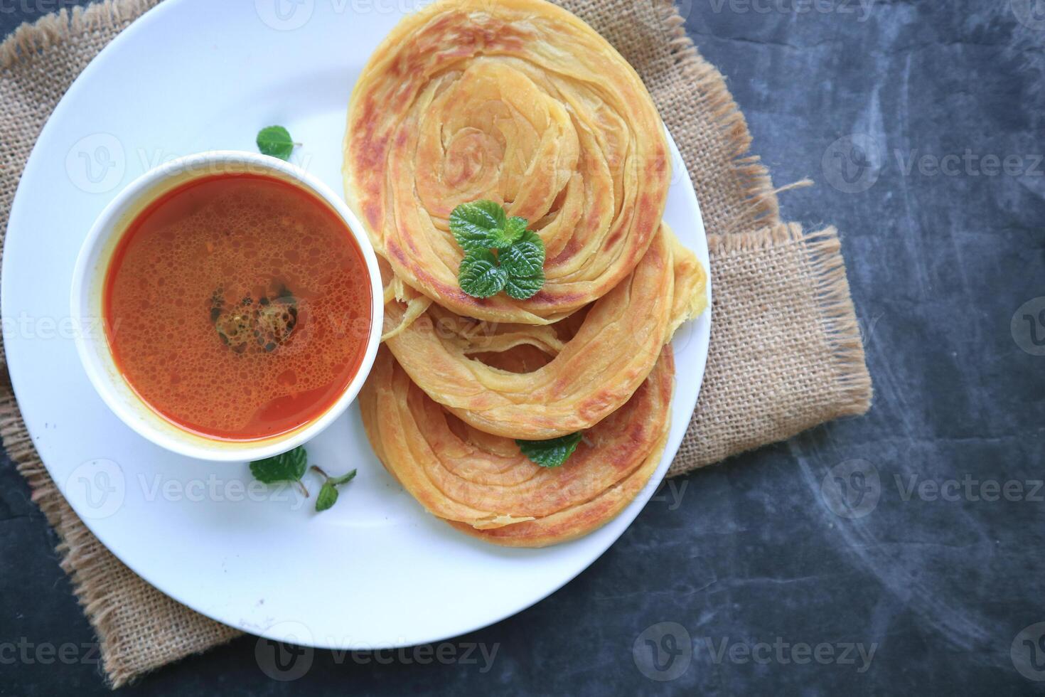 Roti Canai or Paratha Bread with Curry Sauce, Chilli Flakes and Yogurt, Top View photo