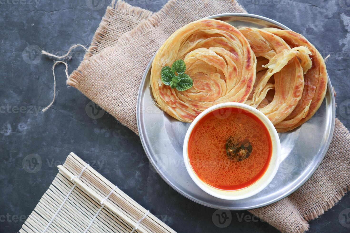 Roti Canai or Paratha Bread with Curry Sauce, Chilli Flakes and Yogurt, Top View photo