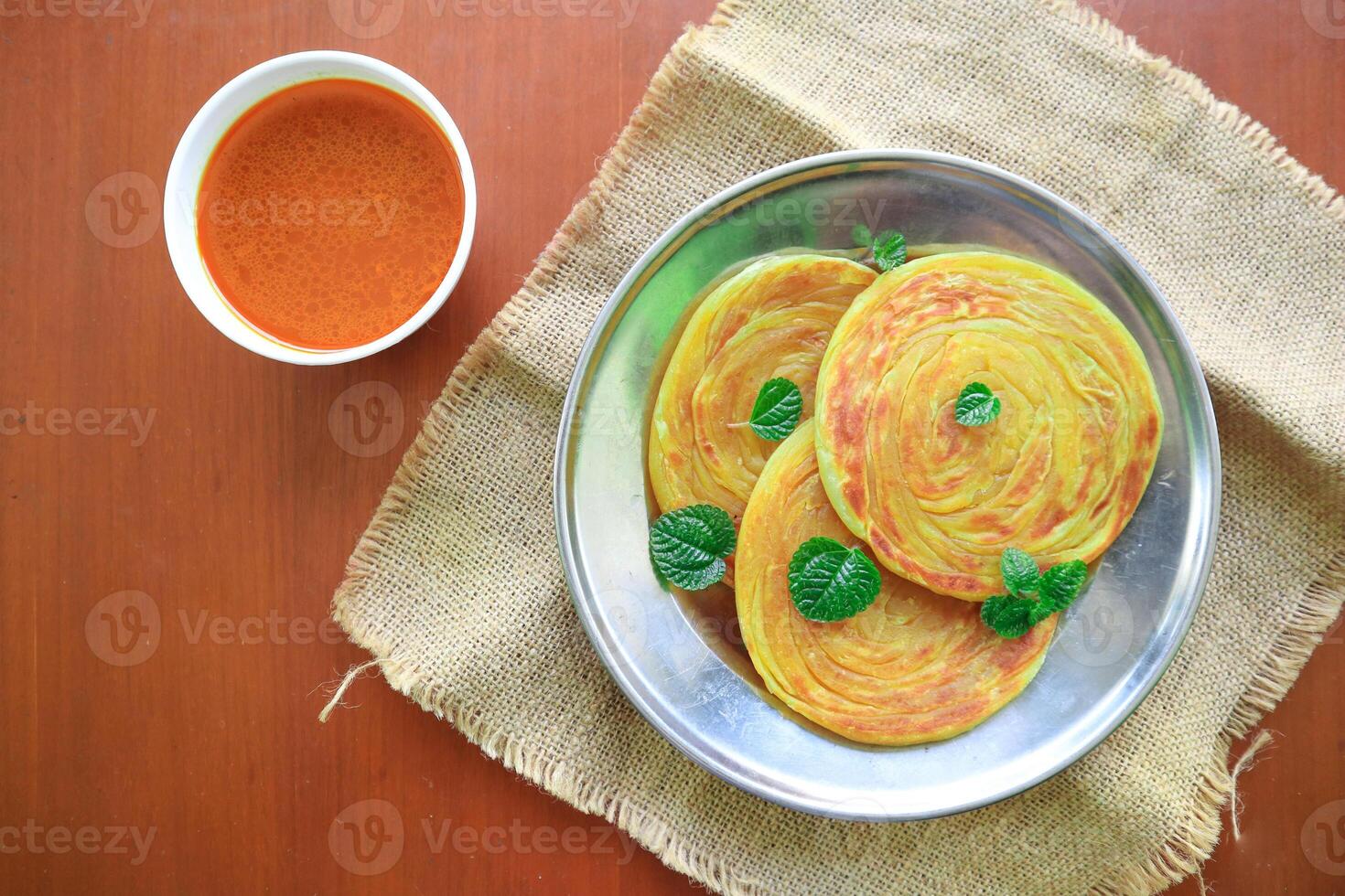 Roti Canai or Paratha Bread with Curry Sauce, Chilli Flakes and Yogurt, Top View photo