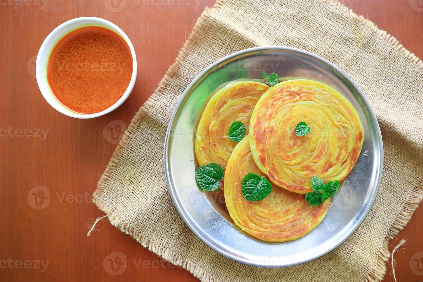 Roti Canai or Paratha Bread with Curry Sauce, Chilli Flakes and Yogurt, Top View photo