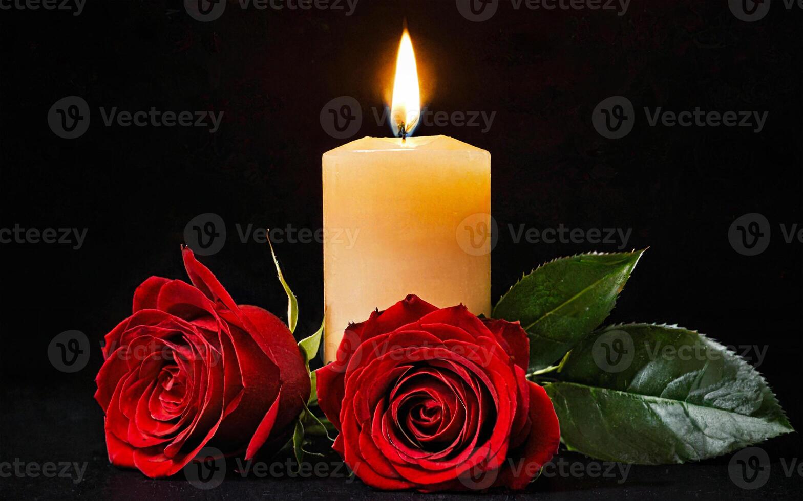 burning yellow candle and two red roses on a black background photo