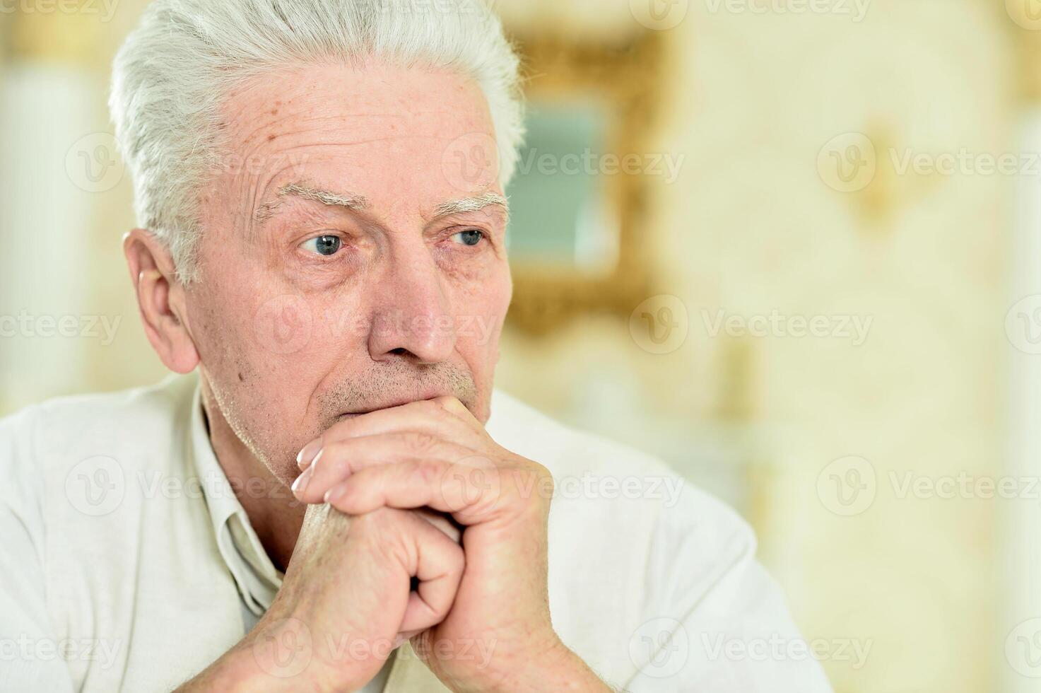 Close up portrait of thoughtful senior man photo