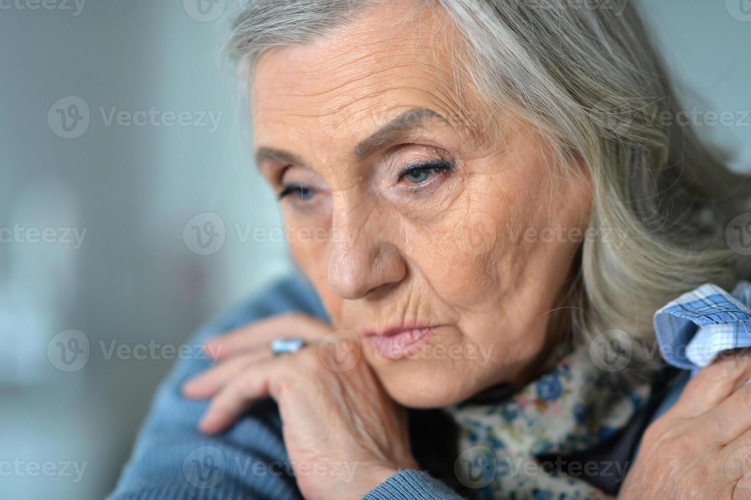 Portrait of sick senior woman at home photo