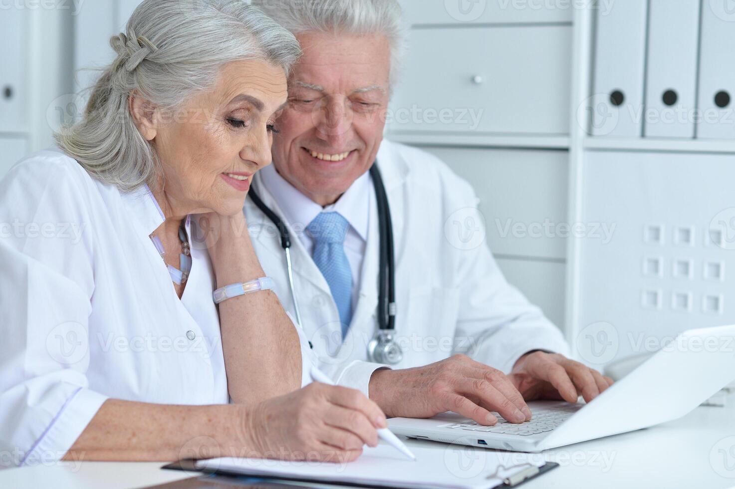 Portrait of professional doctors working in cabinet photo