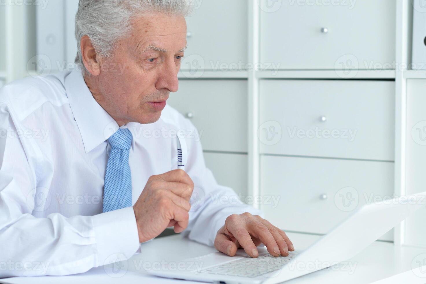 Close up portrait of thoughtful senior businessman photo