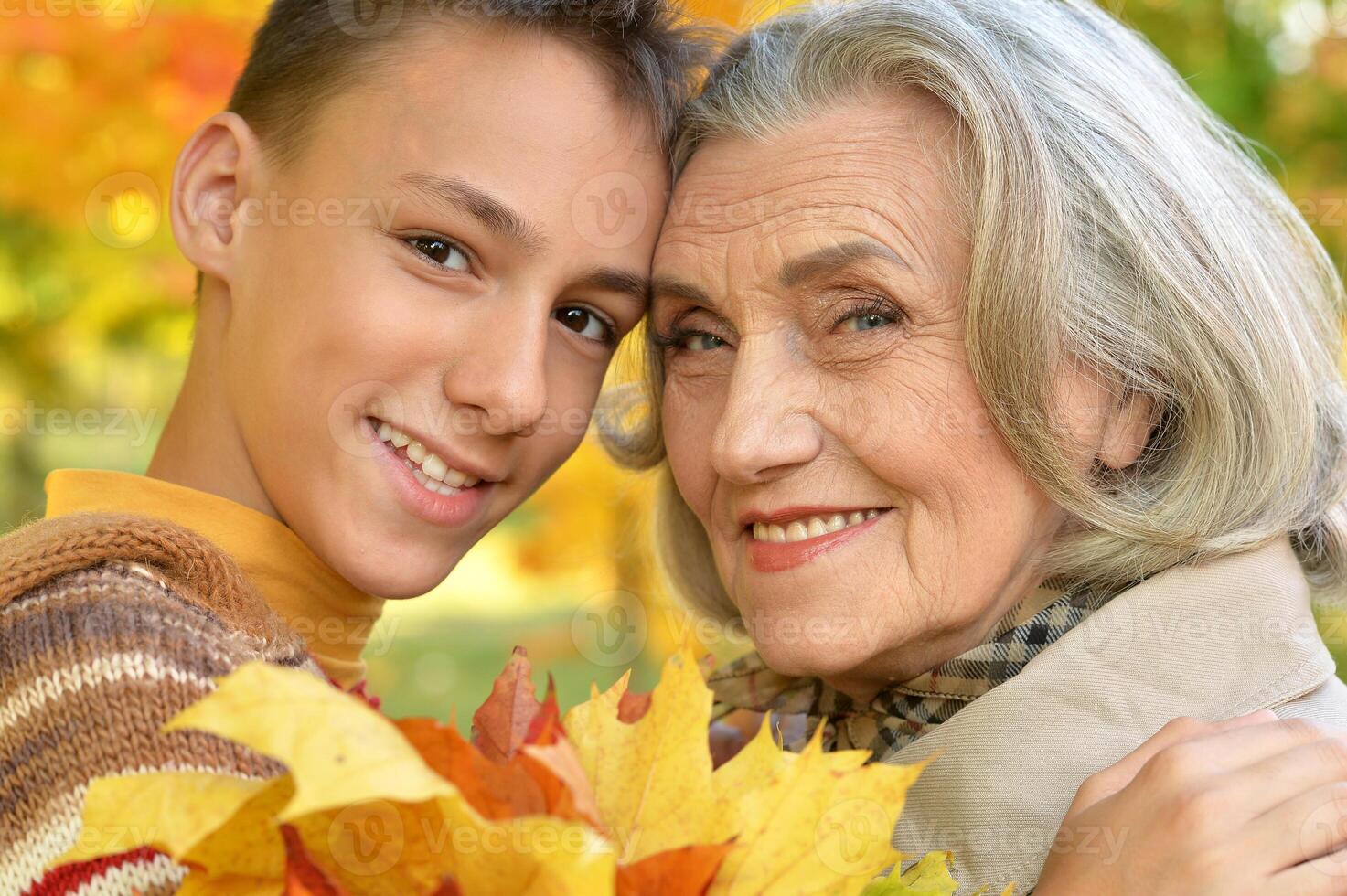 Portrait of happy grandmother and grandson posing photo