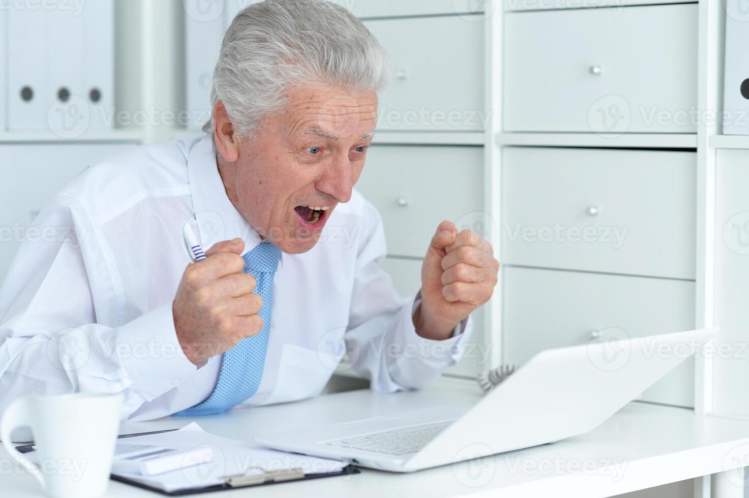 Close up portrait of happy senior businessman photo