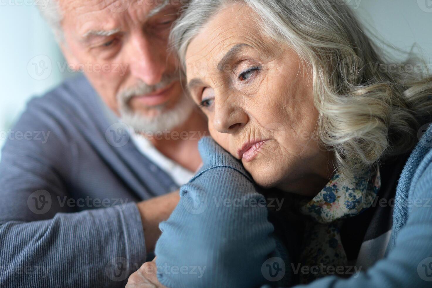 Close-up portrait of sad senior couple posing photo