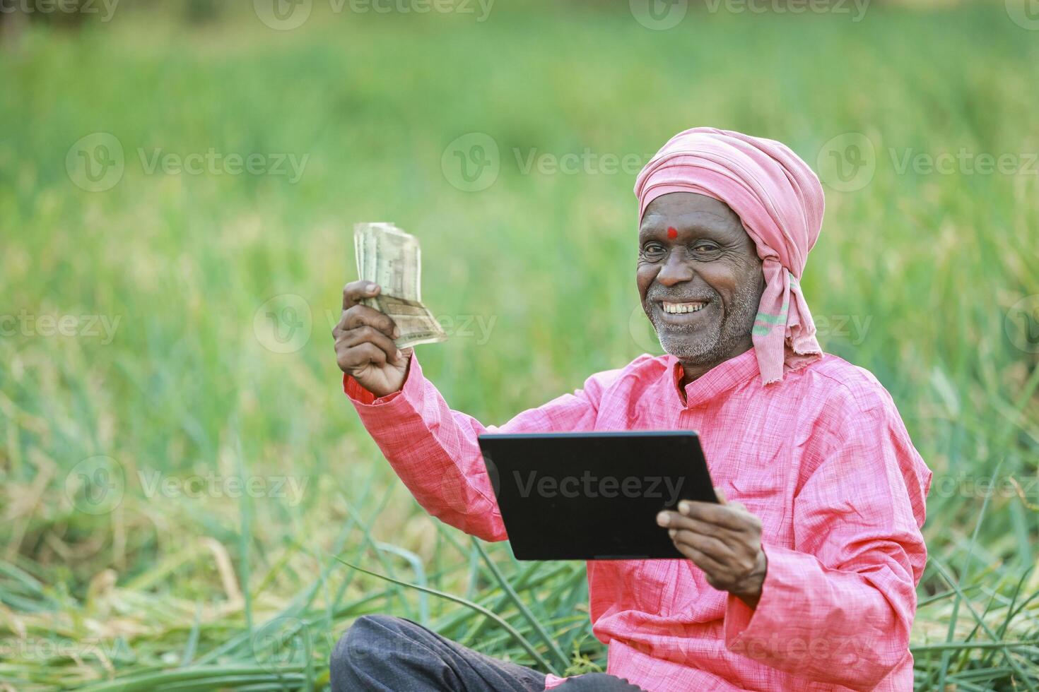 Indian farm worker holding tablet photo