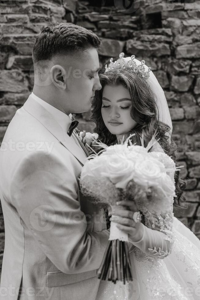 A man and woman are embracing each other, with the woman holding a bouquet of flowers. Concept of love and affection between the couple, as they share a tender moment together photo