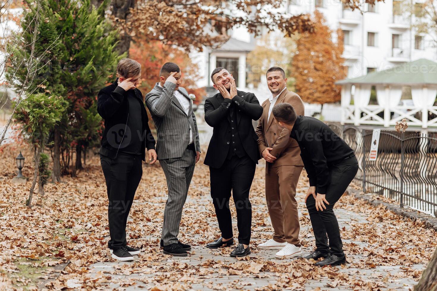 A group of men are posing for a picture in a park photo