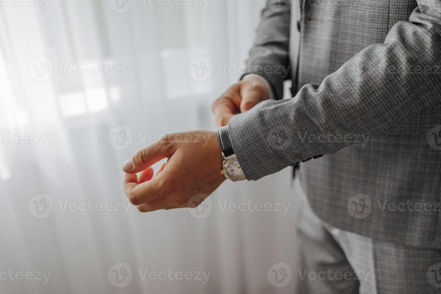 A man is wearing a suit and a watch photo