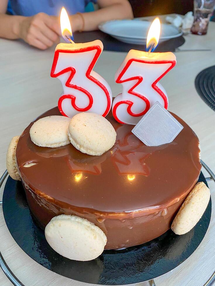 Birthday cake with candles in the shape of the number 33 photo