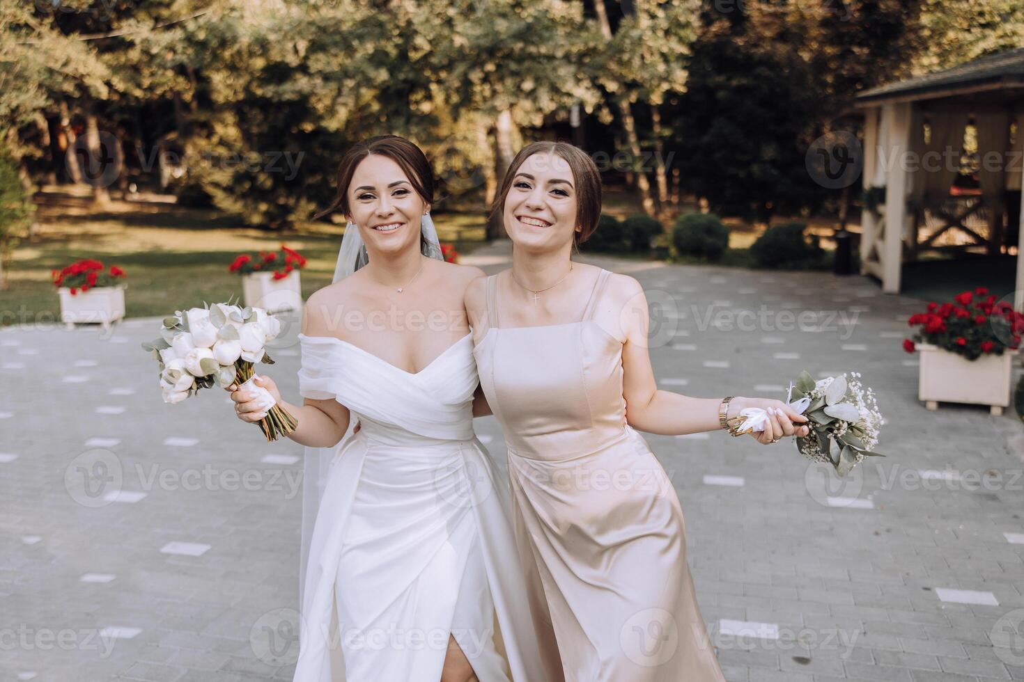 Two women are smiling and holding flowers photo