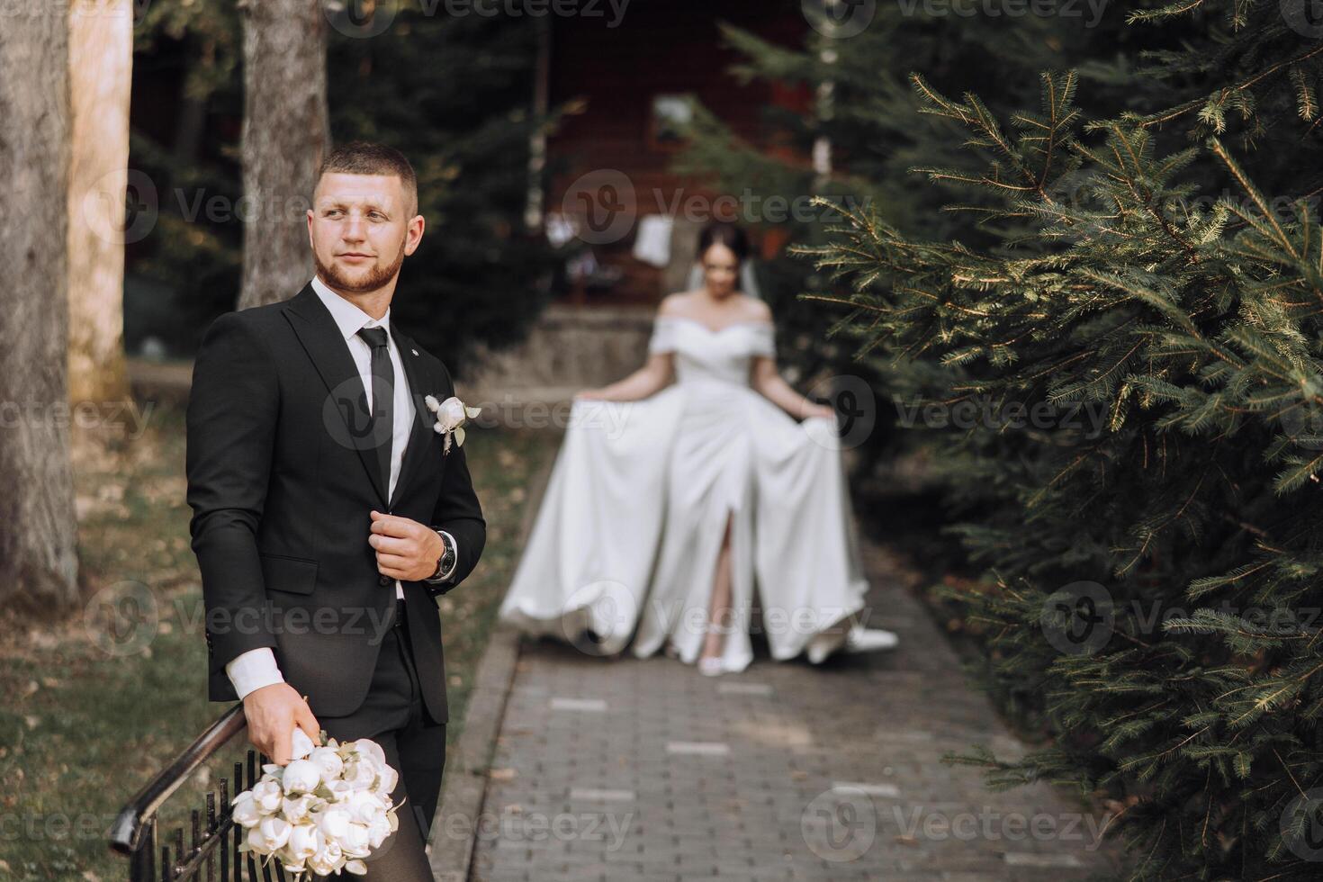 A man and a woman are standing in front of a tree photo