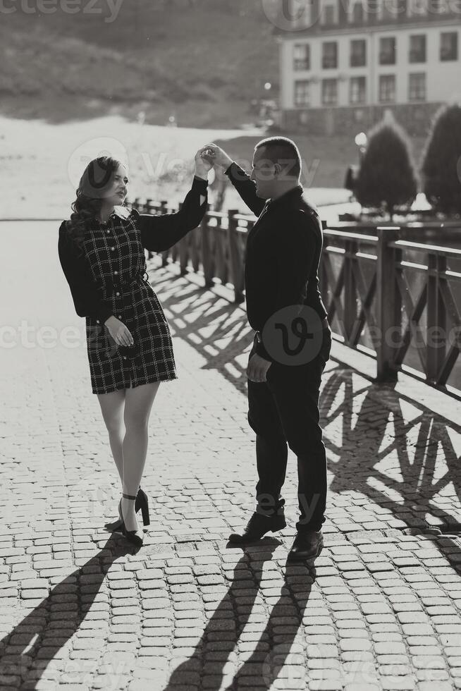 A man and woman are dancing on a sidewalk photo