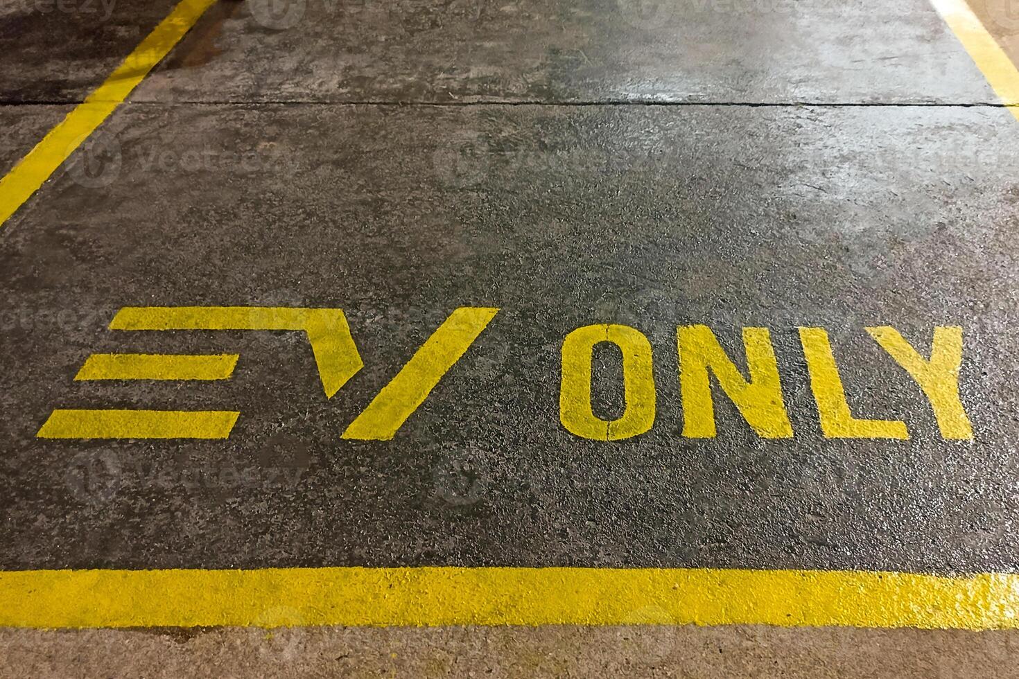 An area for writing EV Only messages and a space for parking EV cars to charge their batteries. photo