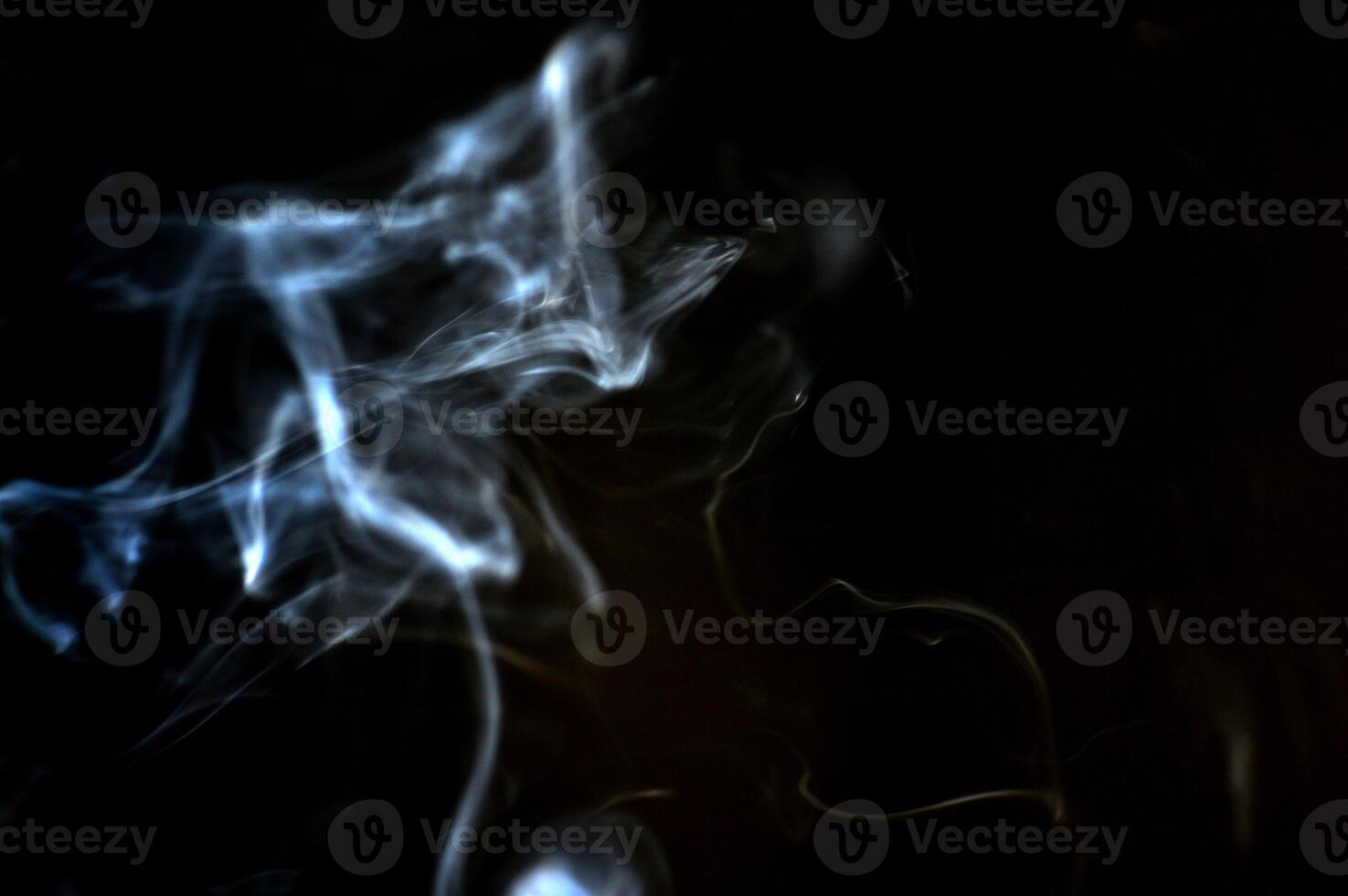 Ethereal Wisps of Smoke on a Dark Background Creating a Mysterious and Abstract Atmosphere photo