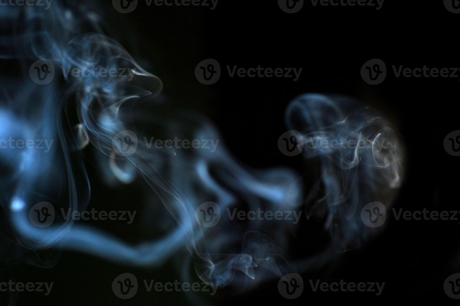 Ethereal Swirls of Smoke Against a Dark Background Capturing the Mystical and Abstract Beauty of Vapor photo