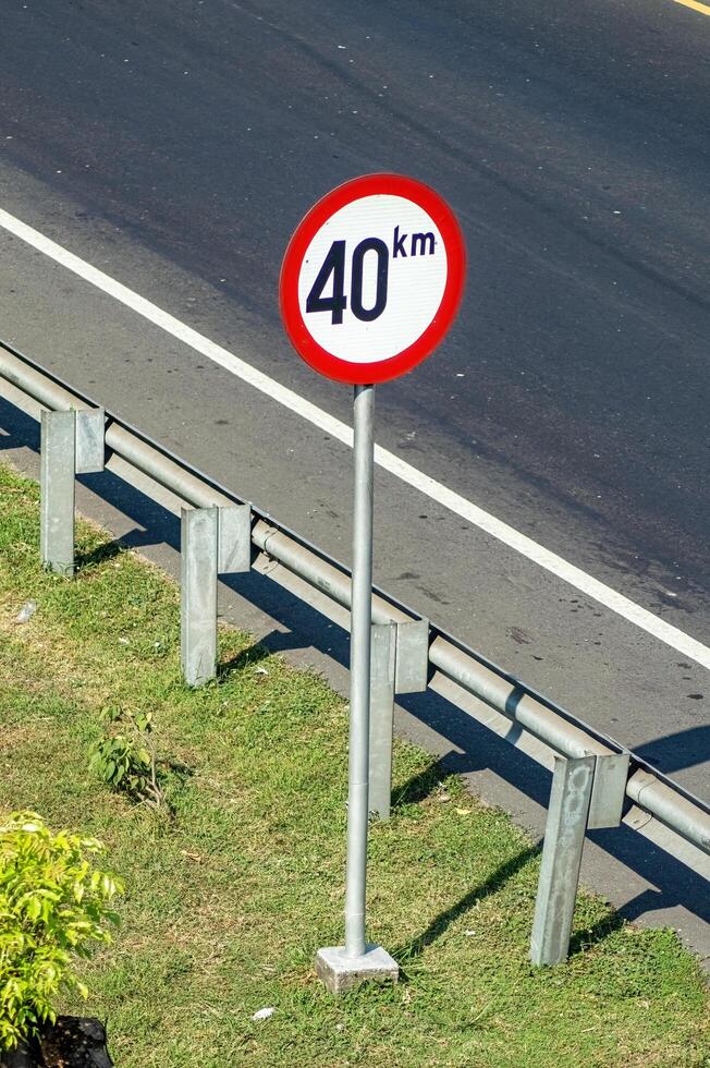 Speed limit and minimum speed signs on Indonesian Toll roads. The maximum speed limit is 40 KM per hour, Indonesia, 16 July 2024. photo