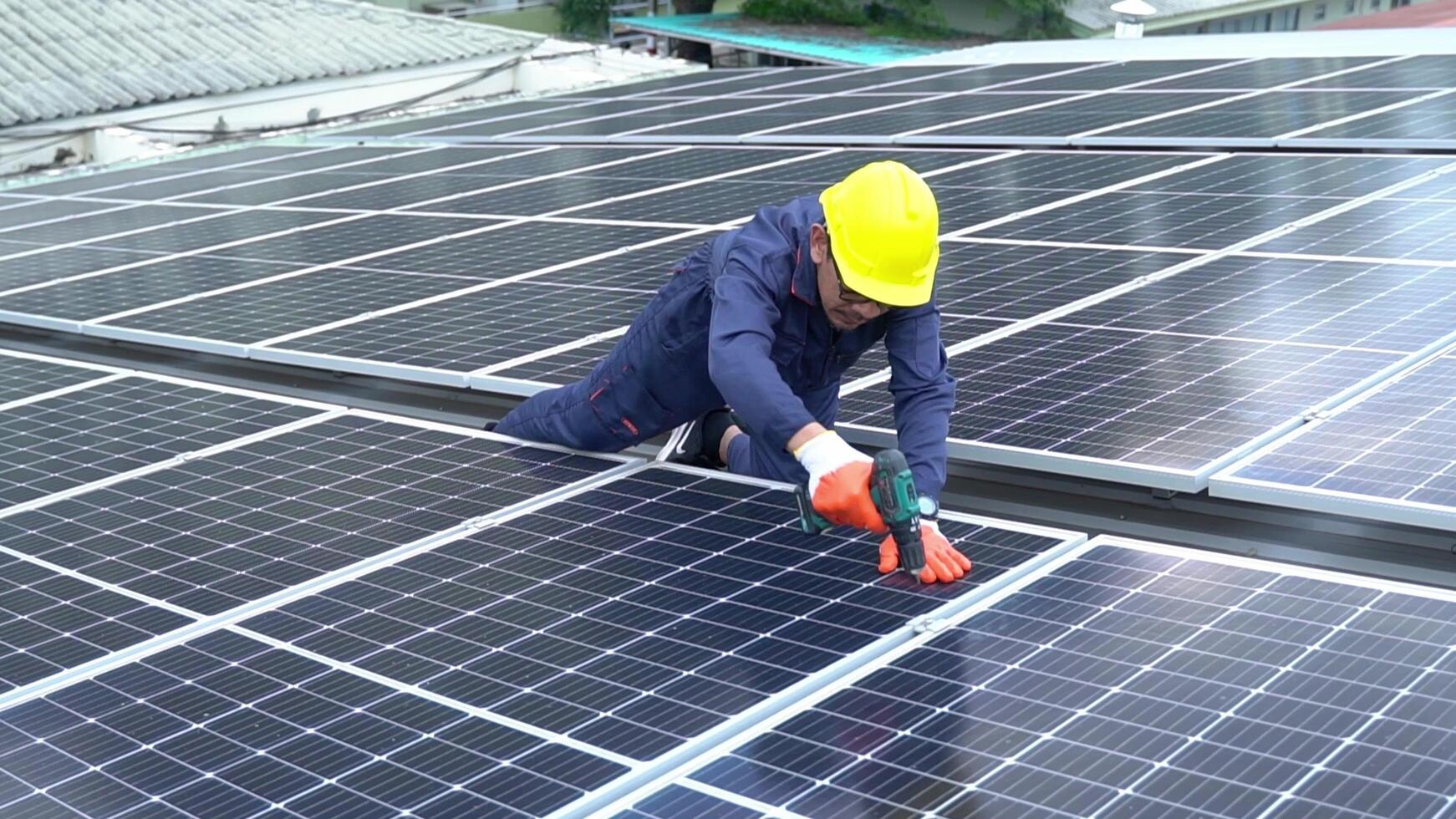 A Technician using drill installing solar cells. photo