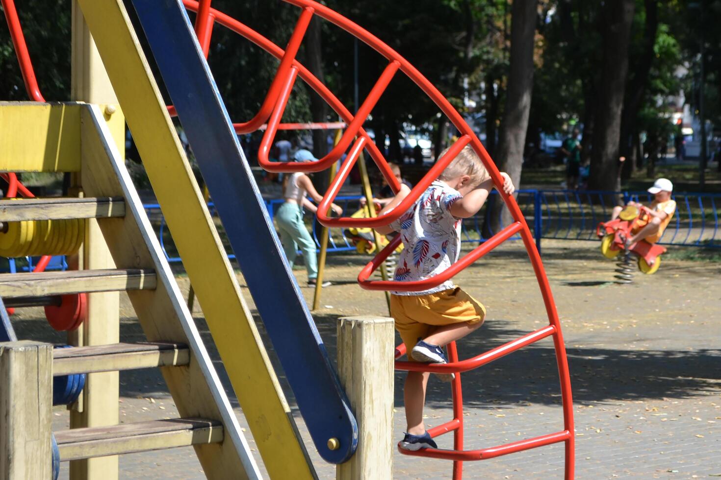 Little children run around and play in the playground. photo