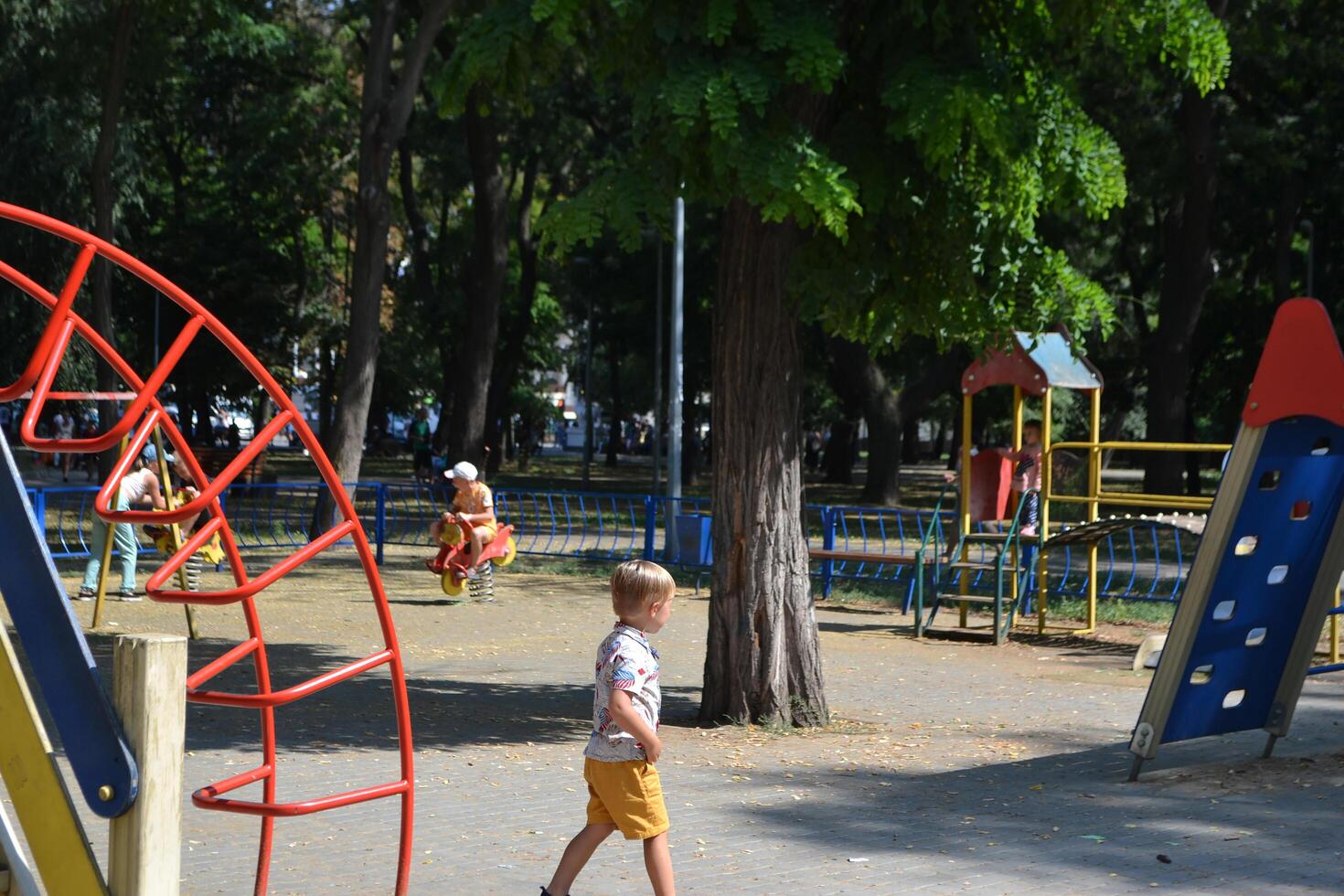 Little children run around and play in the playground. photo