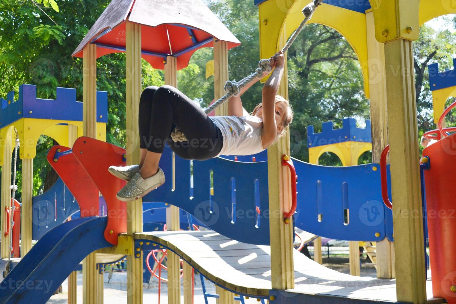 Little children run around and play in the playground. photo