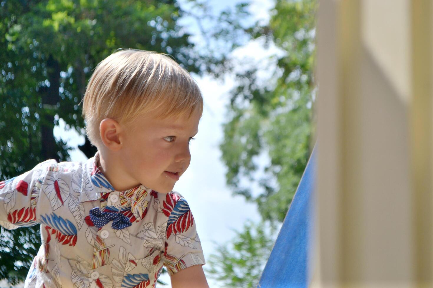 Little children run around and play in the playground. photo
