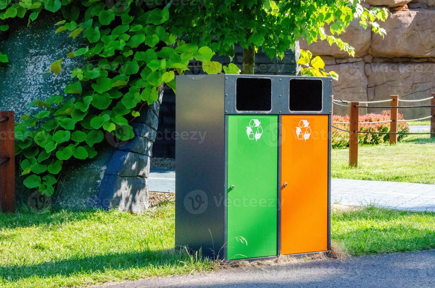 Multicolored metal tanks for separate garbage collection in a nature park photo