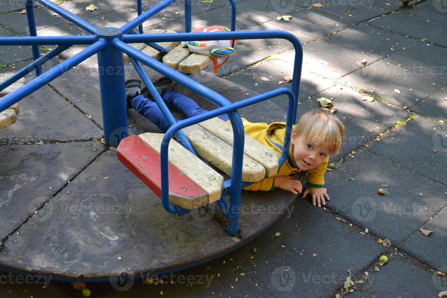 Little children run around and play in the playground. photo