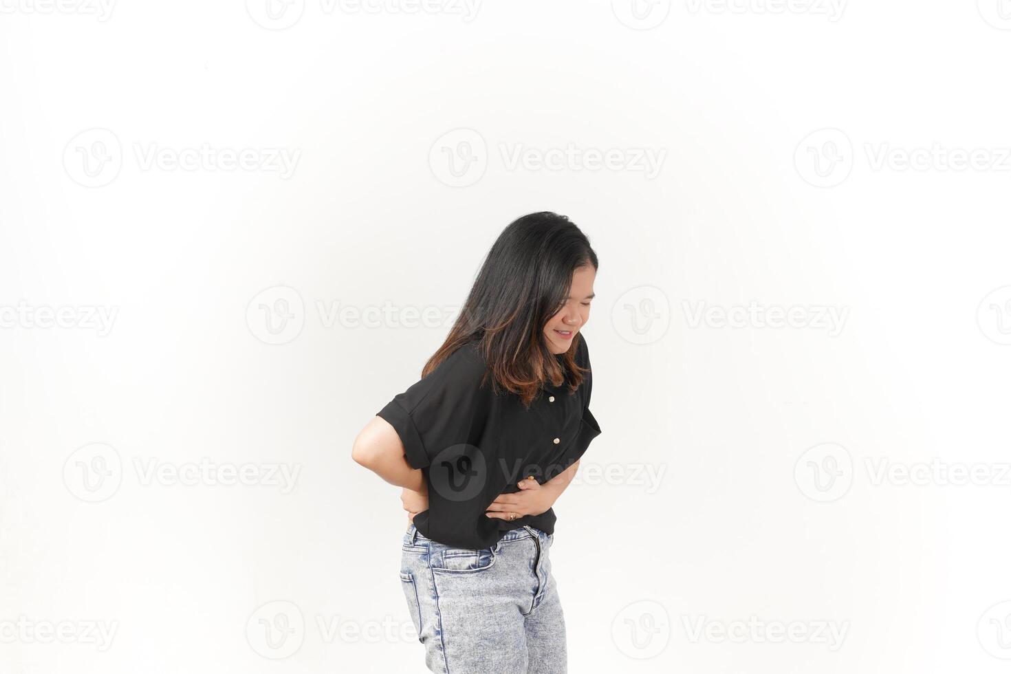 Young Asian woman Pain on stomach, Stomachache wearing Black t-shirt and jeans isolated on white background photo