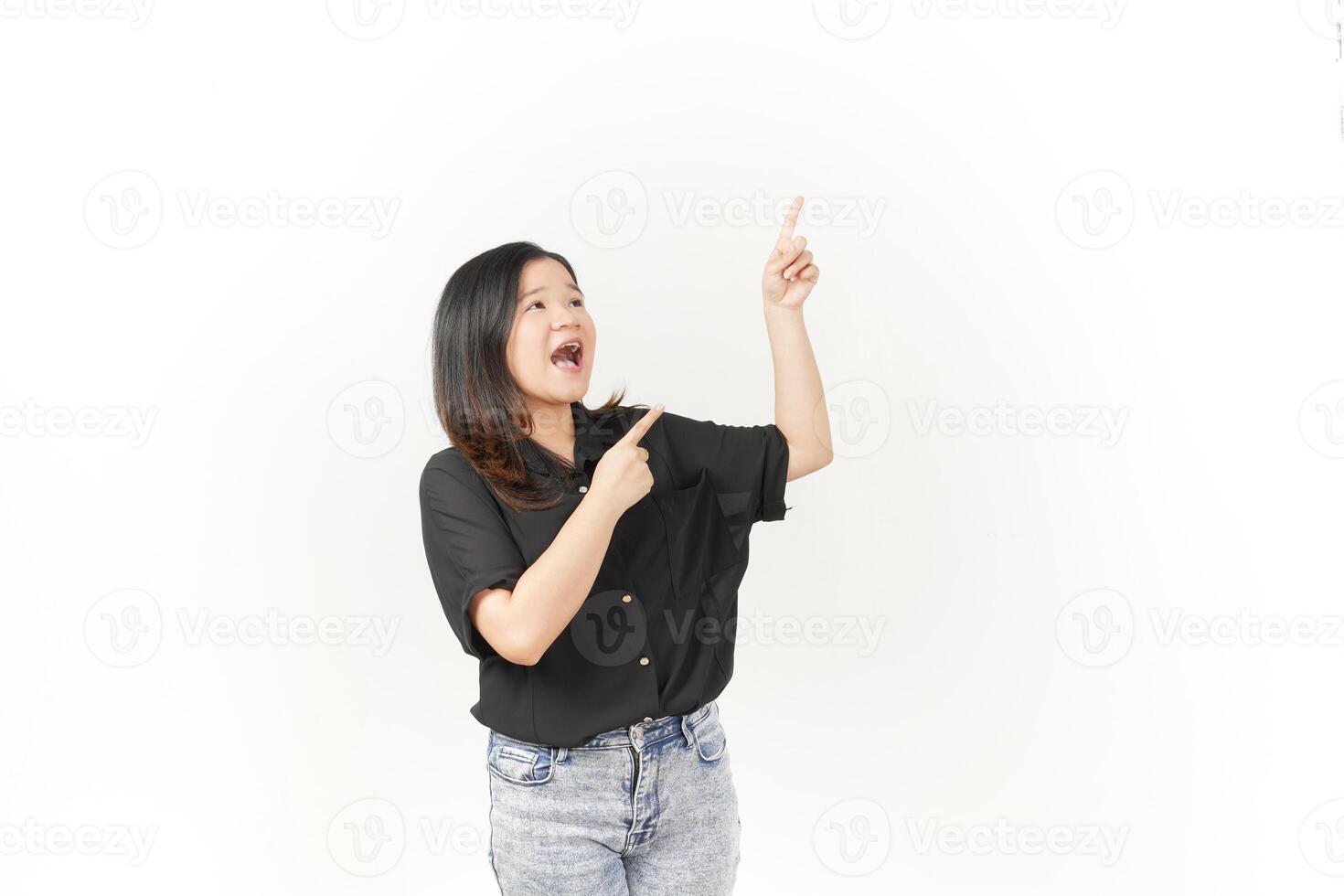 Young Asian woman presenting and pointing side copyspace wearing Black t-shirt and jeans isolated on white background photo