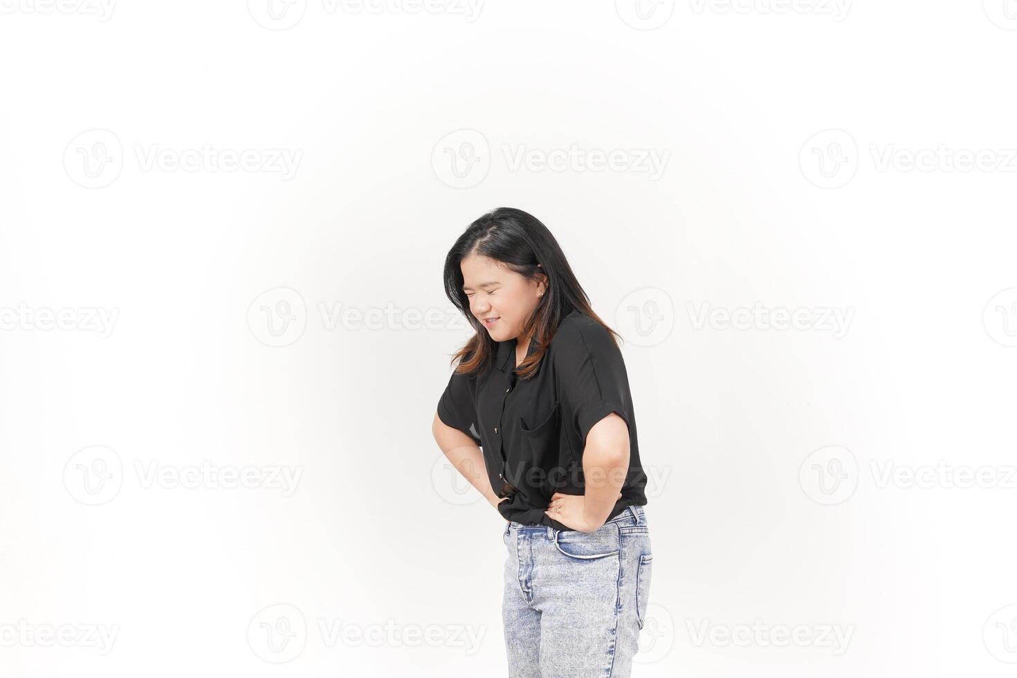 Young Asian woman Pain on stomach, Stomachache wearing Black t-shirt and jeans isolated on white background photo