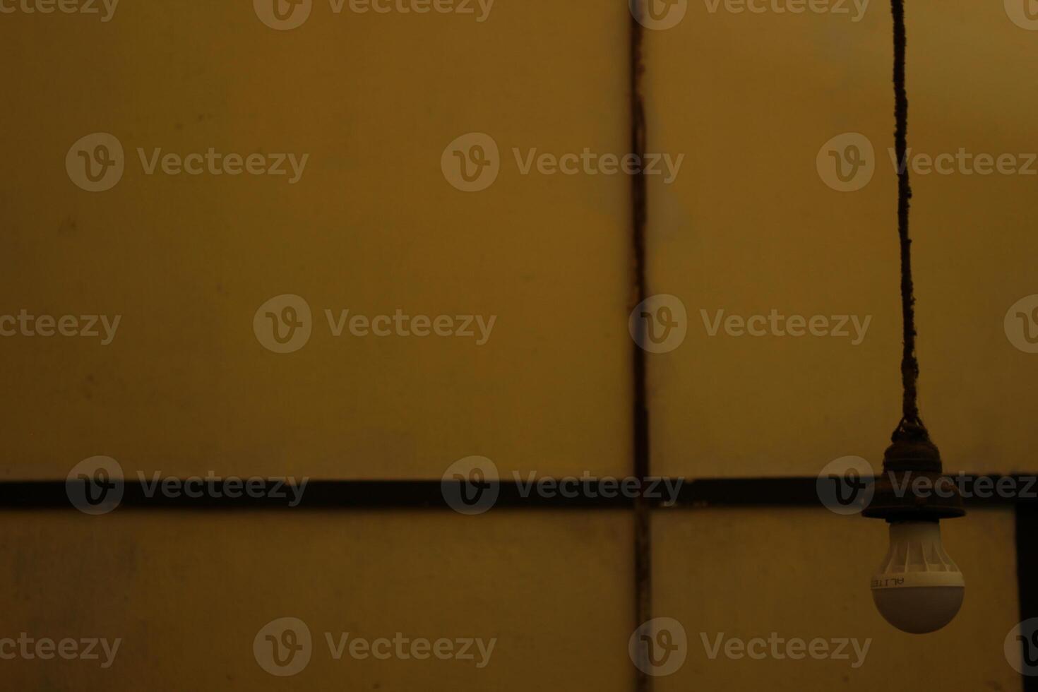 a person standing in front of a yellow wall with a sticker on it photo