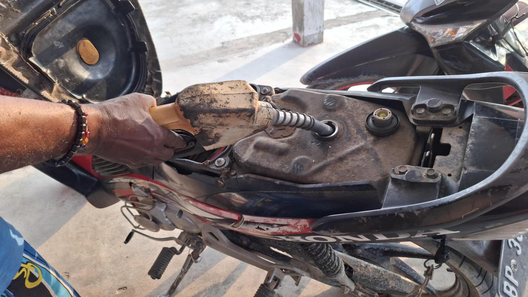 Filling up the tank on a Honda motorcycle photo