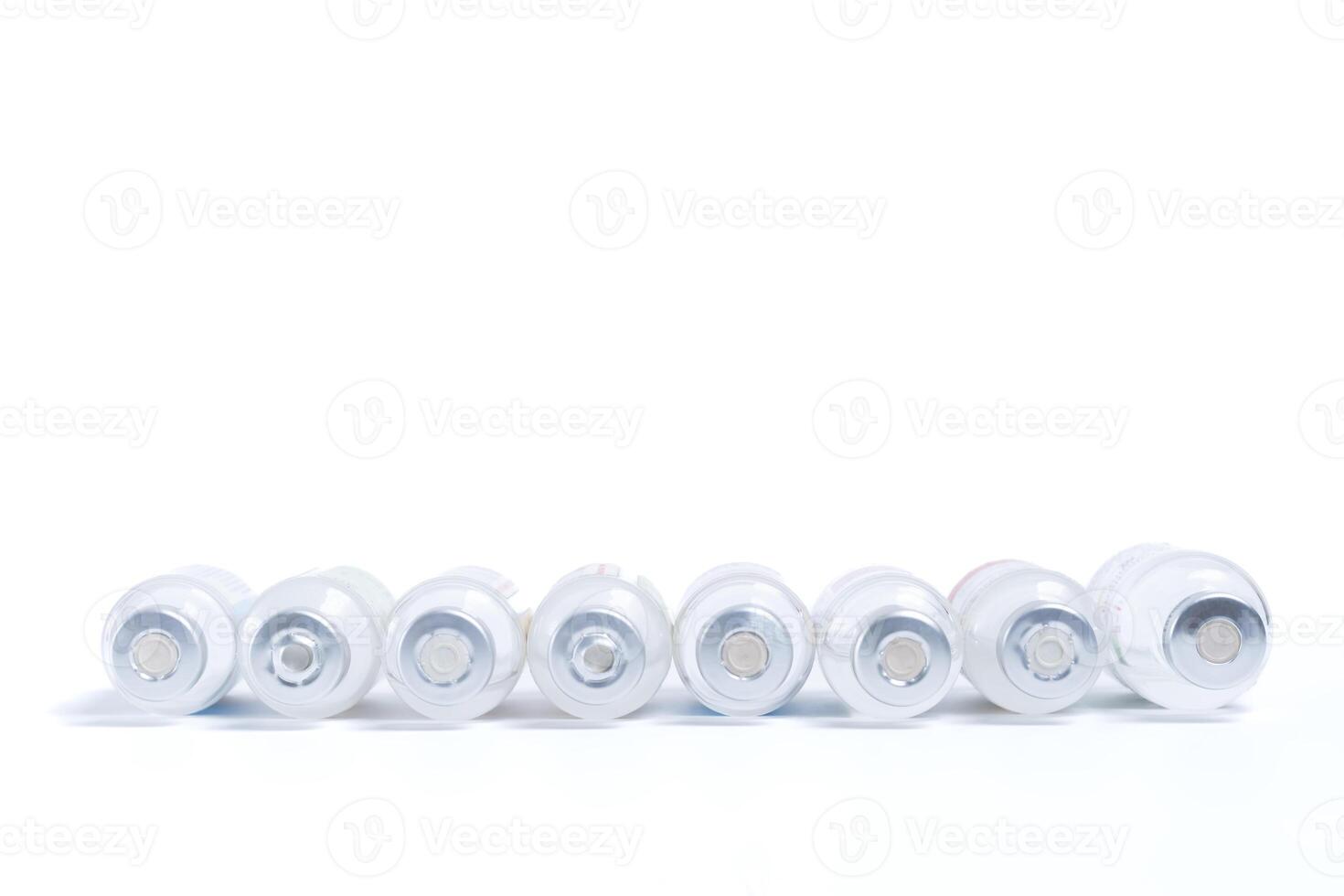 Group of vaccinations bottles leaning down on white background. medical concept photo