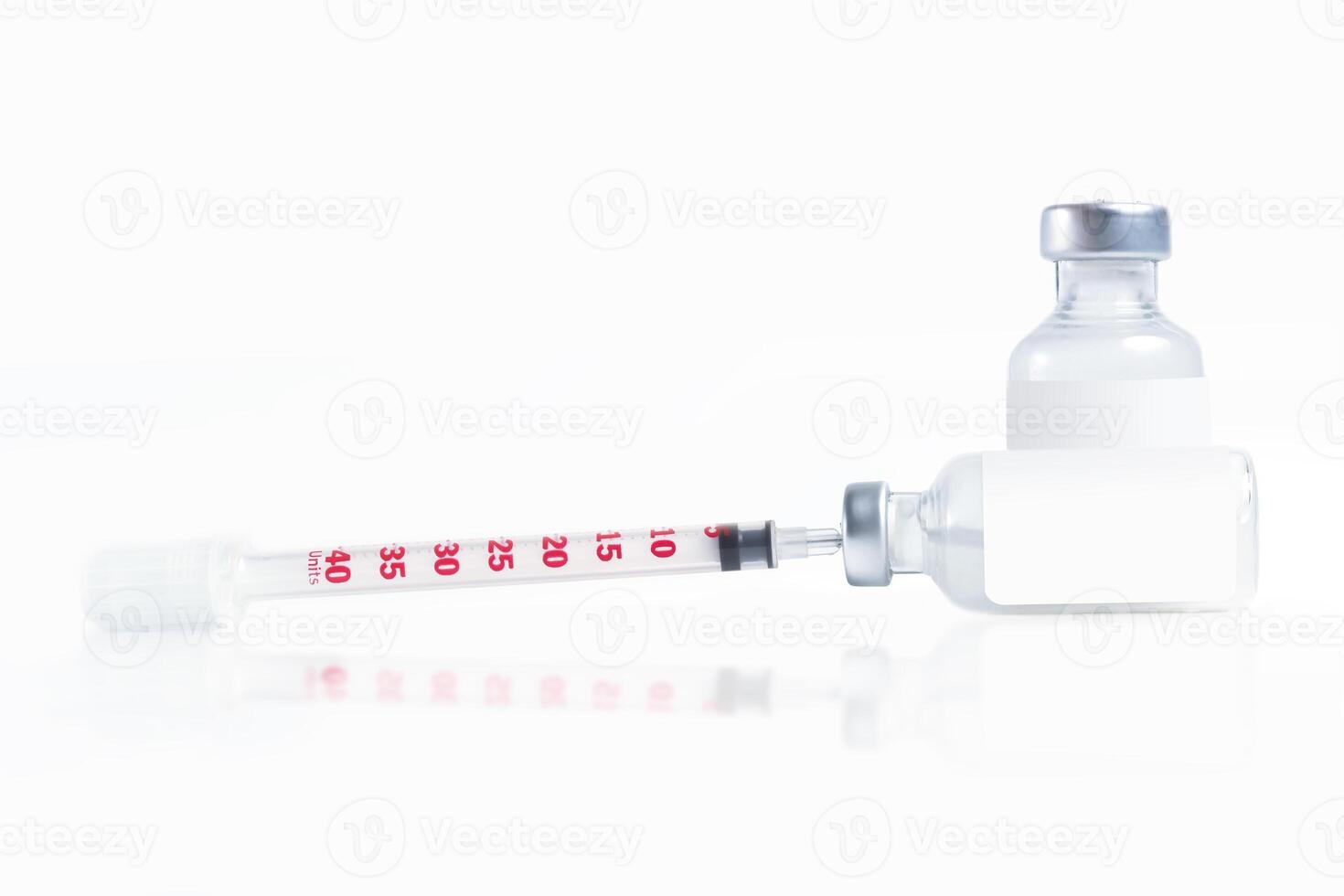 Medical syringe and vaccine vial isolated on a white background photo