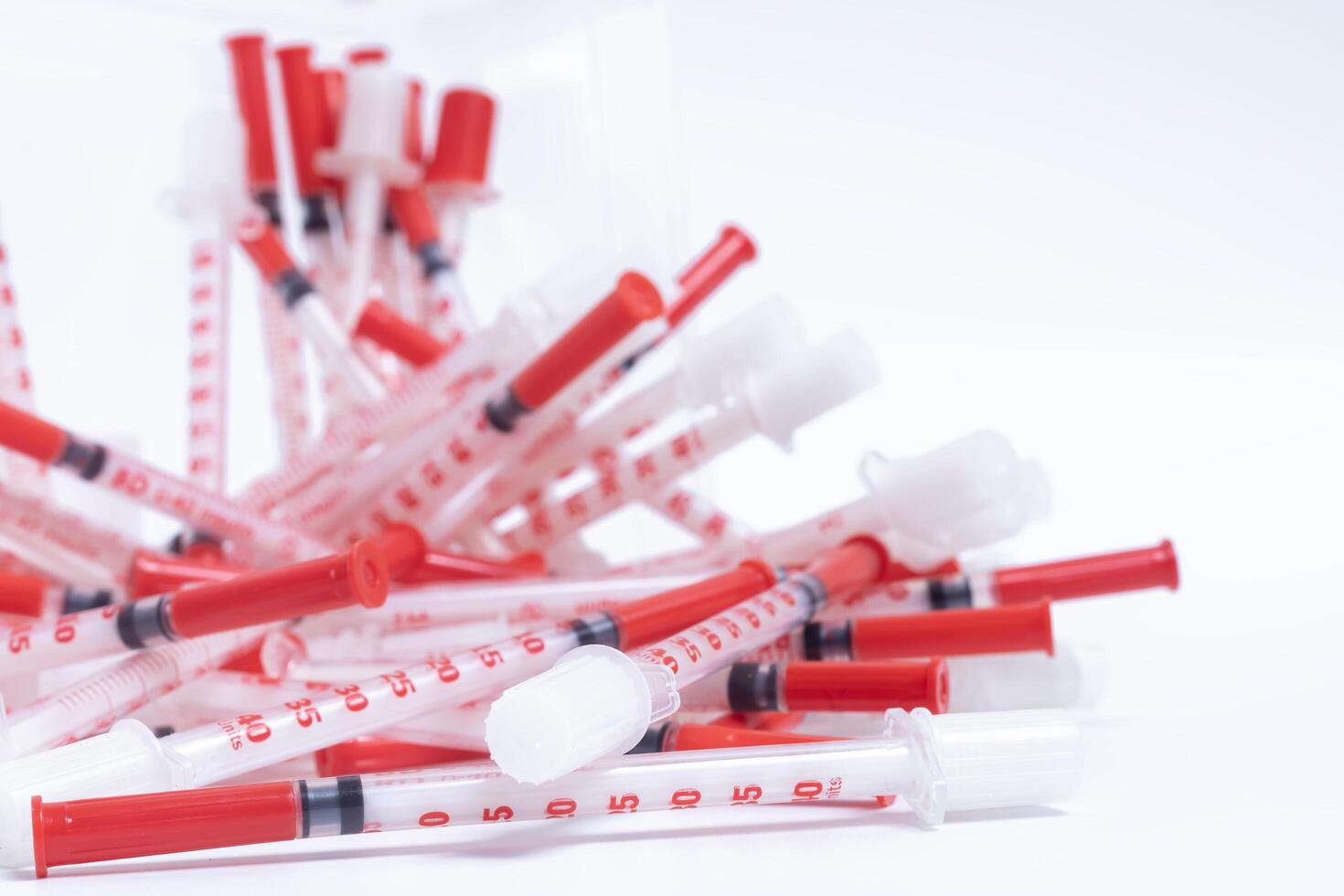 Pile of disposable Medical syringes on a white background. photo