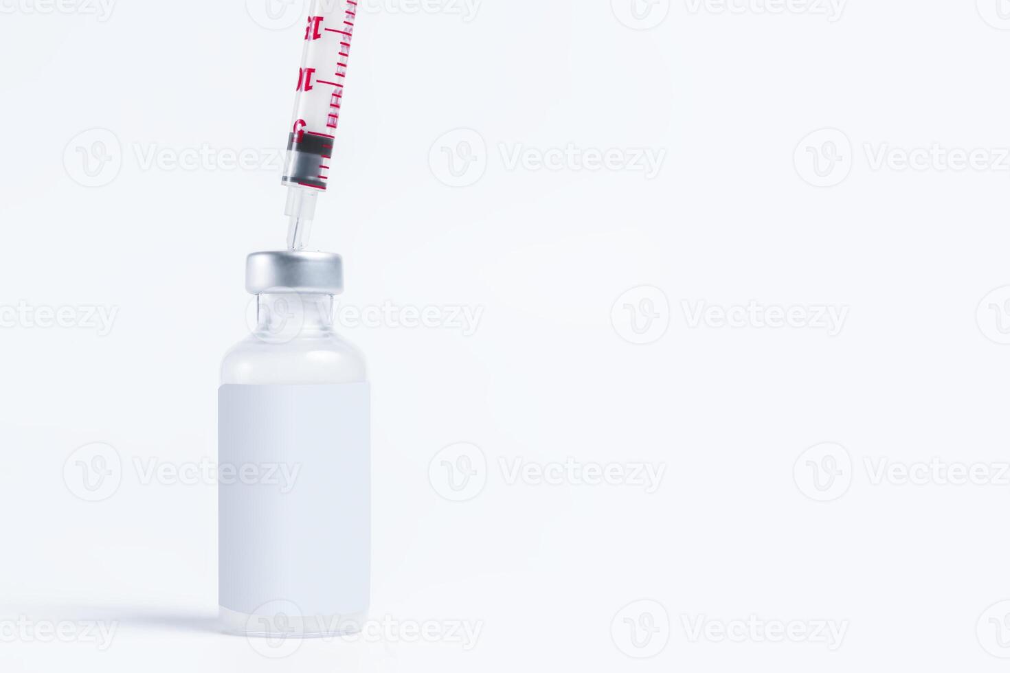 Vaccine vial bottle with a syringe on a white background with copy space. photo