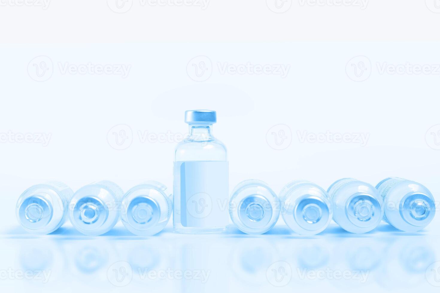 Vaccine bottles lined up on white background with copy space. photo